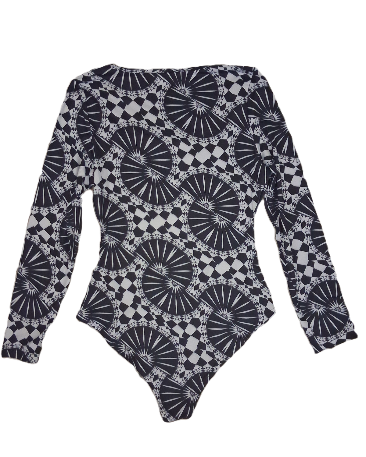 A long-sleeve bodysuit featuring an all-over black and white geometric pattern with circular sunburst and checkerboard motifs, laid flat against a white background.