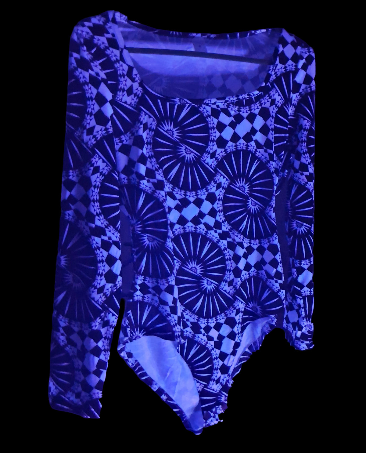 A long-sleeve bodysuit with a black and blue geometric pattern featuring fan-like and diamond motifs, displayed on a hanger under blue light.